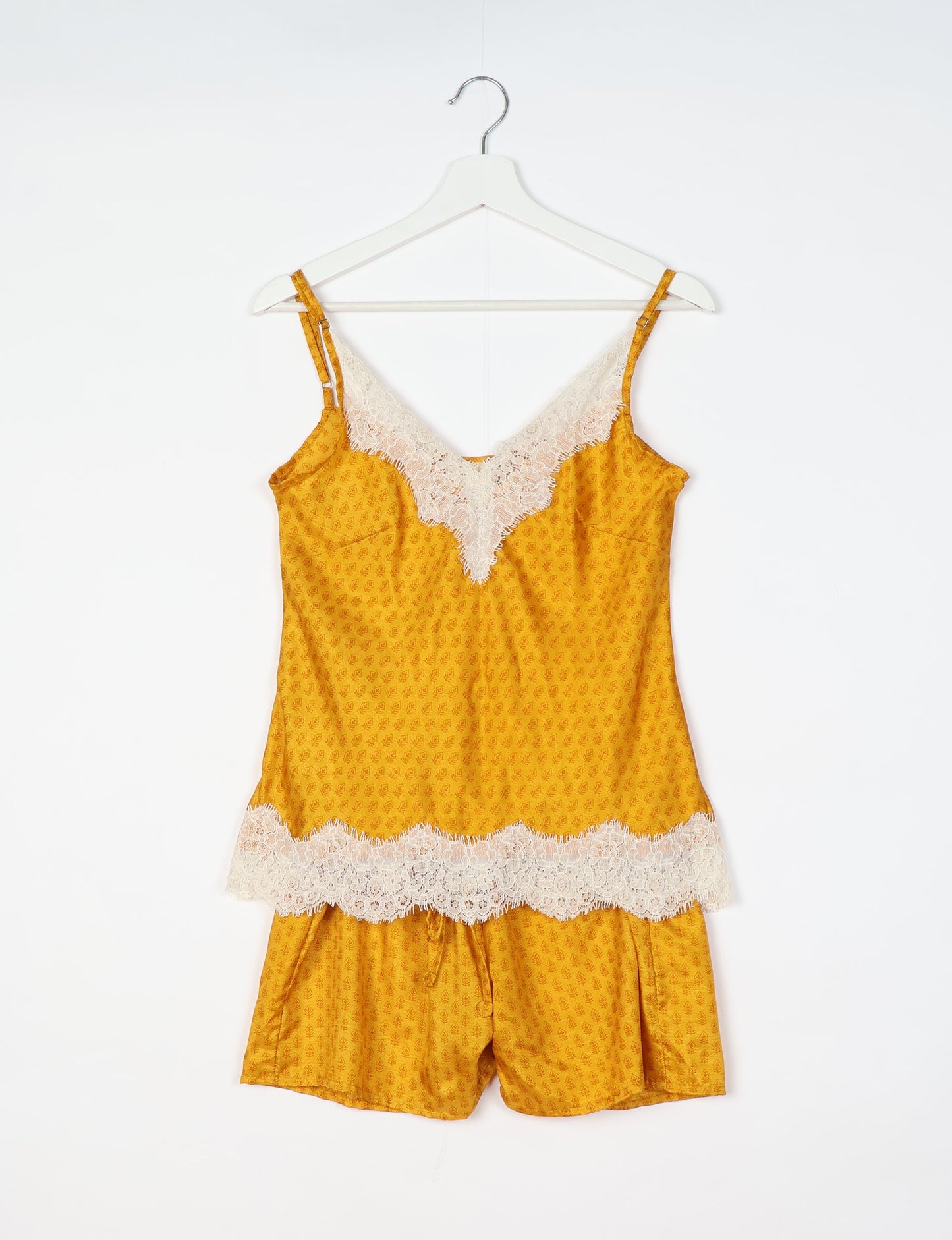 Sleep in eco-friendly luxury with our PJ Set Short. Made for the conscious consumer, these pajamas contribute to zero waste and sustainable practices. The cami top, adorned with delicate eyelash lace and cut on the bias, pairs seamlessly with the comfy shorts featuring an elasticated waist and drawstring tie.