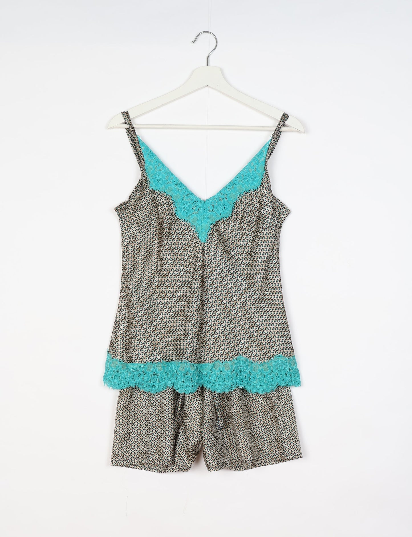 Sleep in eco-friendly luxury with our PJ Set Short. Made for the conscious consumer, these pajamas contribute to zero waste and sustainable practices. The cami top, adorned with delicate eyelash lace and cut on the bias, pairs seamlessly with the comfy shorts featuring an elasticated waist and drawstring tie.