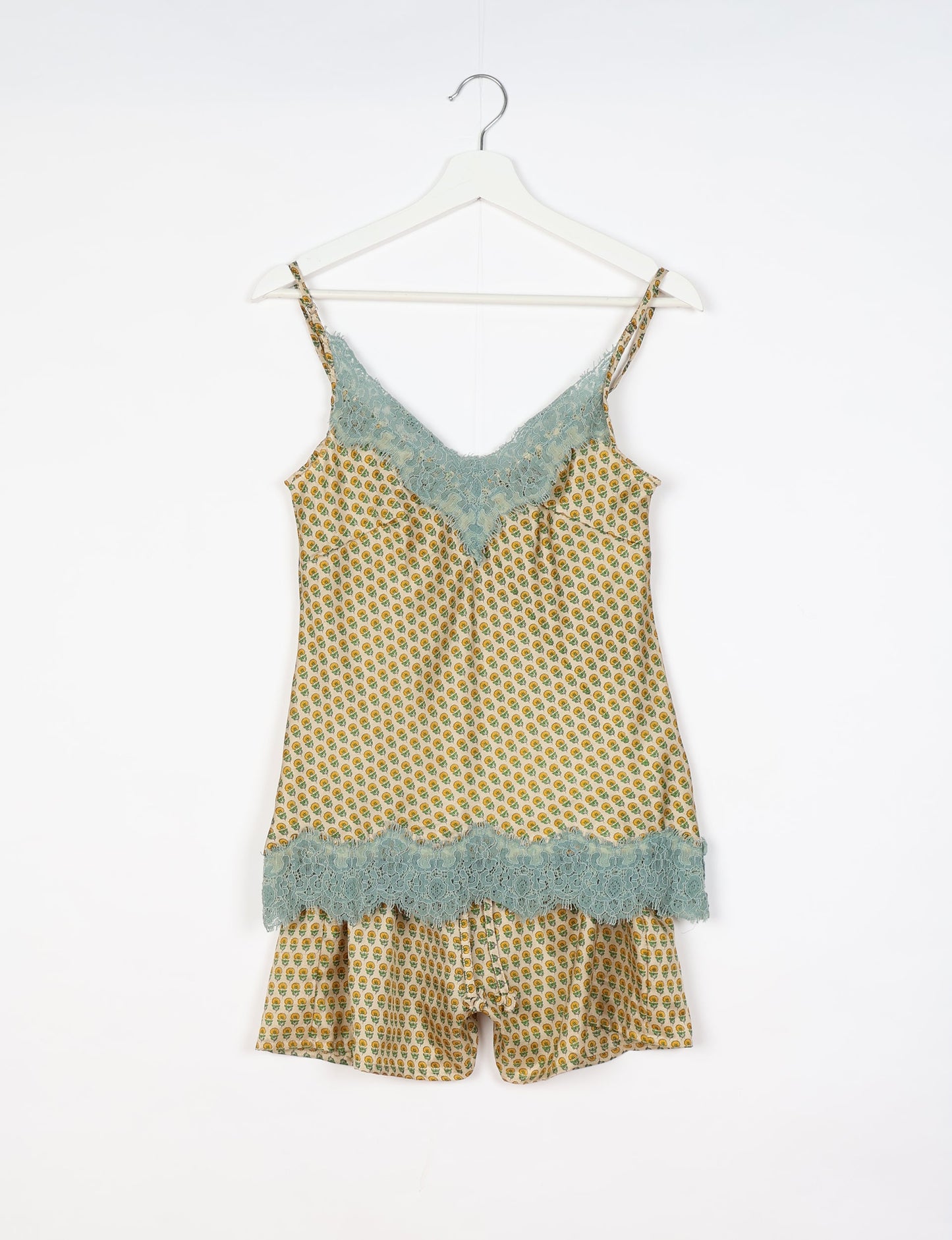 Sleep in eco-friendly luxury with our PJ Set Short. Made for the conscious consumer, these pajamas contribute to zero waste and sustainable practices. The cami top, adorned with delicate eyelash lace and cut on the bias, pairs seamlessly with the comfy shorts featuring an elasticated waist and drawstring tie.