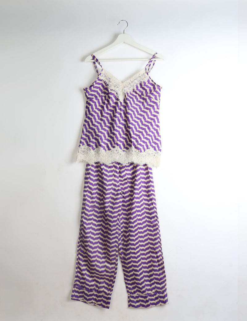 Purple and white abstract patterned pajama set with lace trim on camisole neckline and hem, shown hanging on white hanger