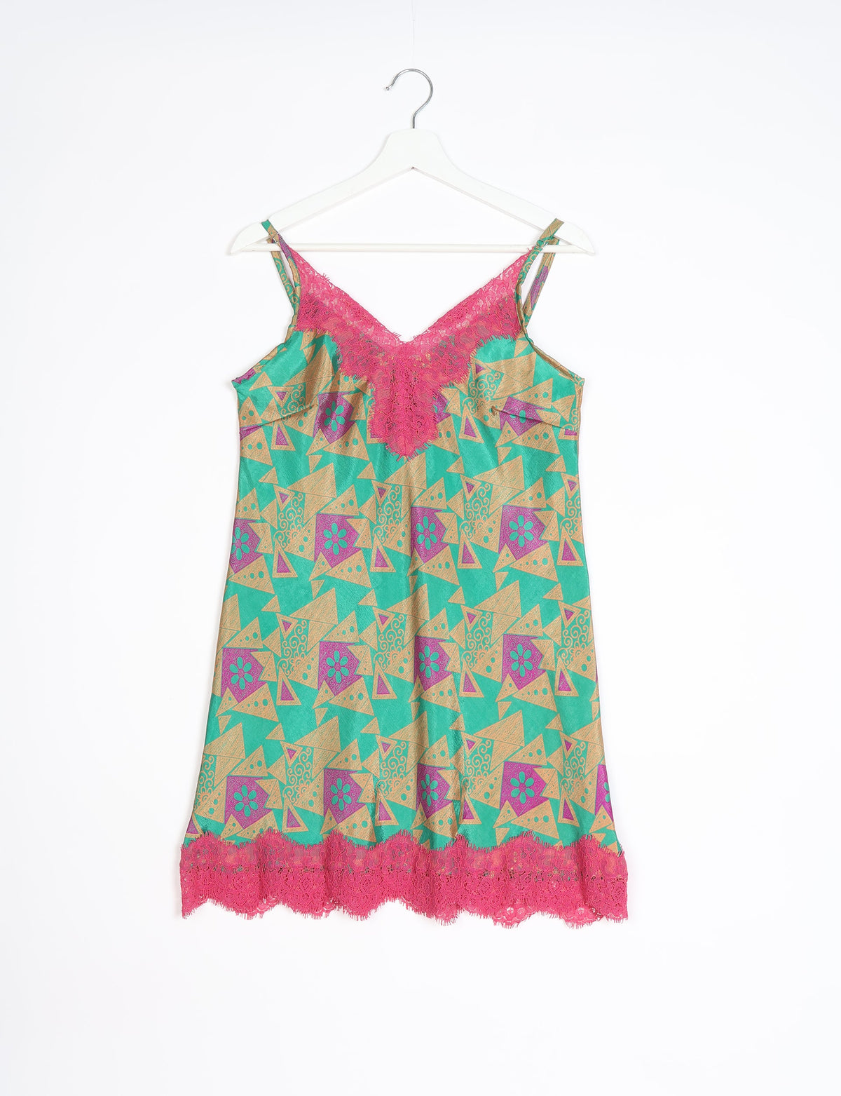Green night dress with geometric tan and purple patterns, pink lace trim on neckline and hem, hanging on white hanger