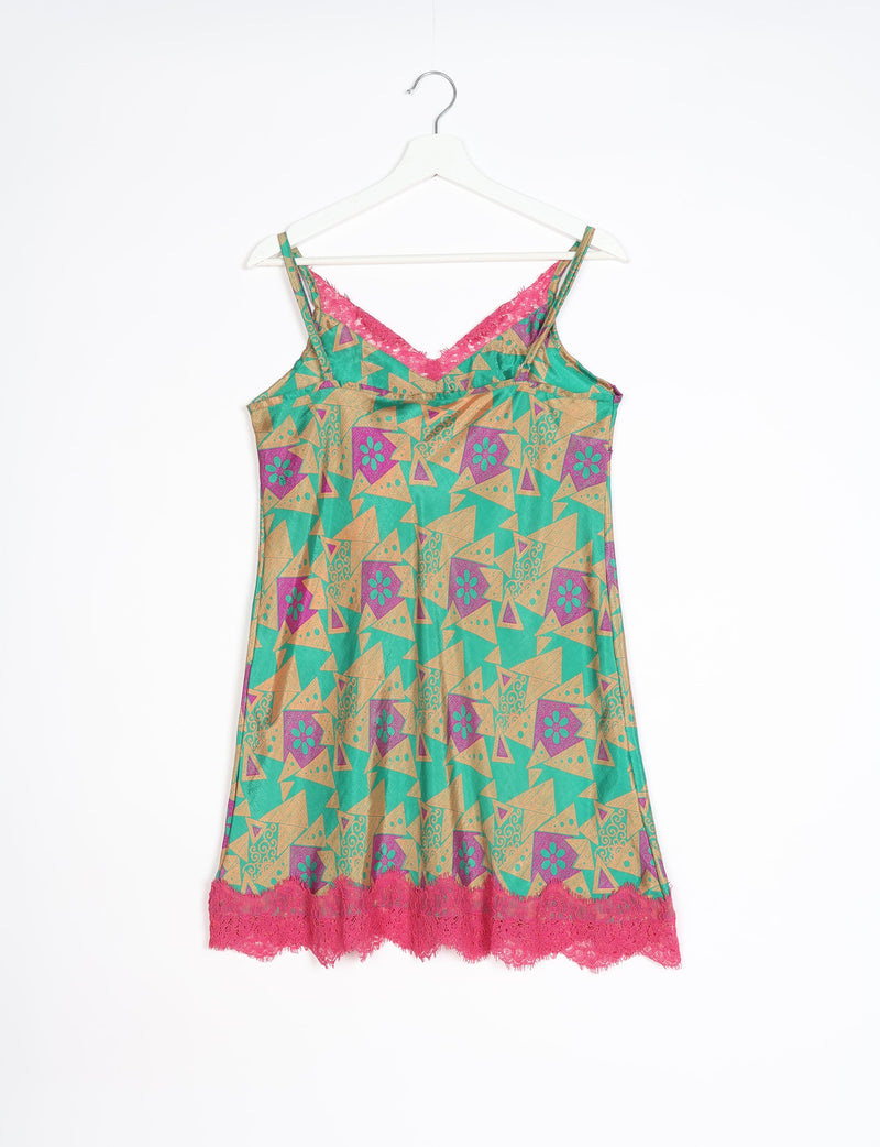 Green night dress with geometric tan and purple shapes, pink lace trim at neckline and hem, shown hanging on white hanger