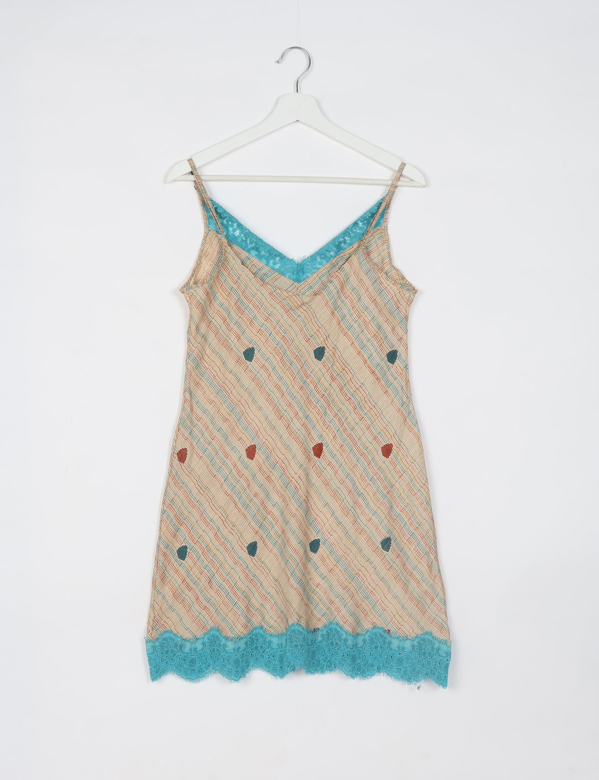 Beige night dress with abstract diagonal stripes, small leaf patterns, turquoise lace trim at neckline and hem, on white