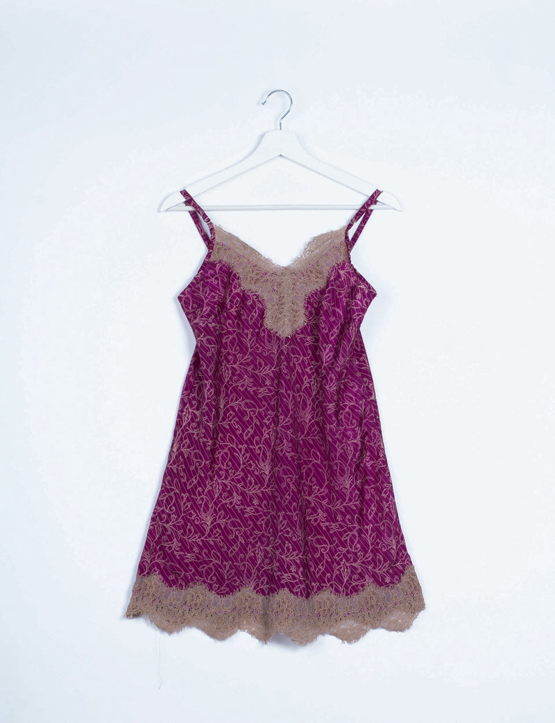 Pink night dress with abstract pattern, beige lace trim on neckline and hem, double shoulder straps, hanging on white hanger