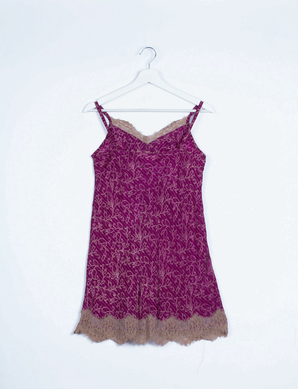 Pink abstract patterned night dress with beige lace trim at neckline and hem, hanging on white hanger, front view
