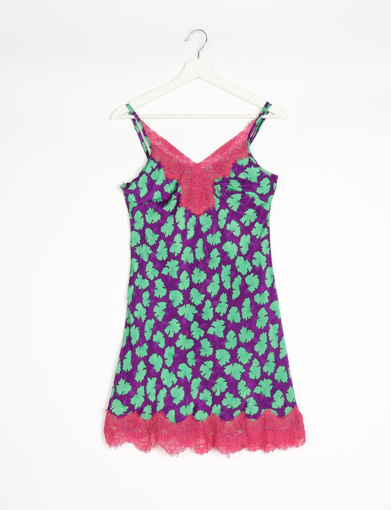 Purple night dress with green leaf pattern, pink lace trim at neckline and hem, adjustable straps, hanging on white hanger