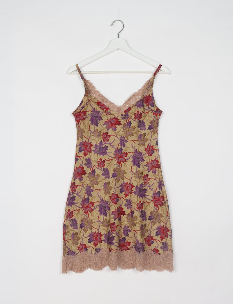 Beige night dress with red and purple leaf print, lace trim at neckline and hem, hanging on white hanger, front view
