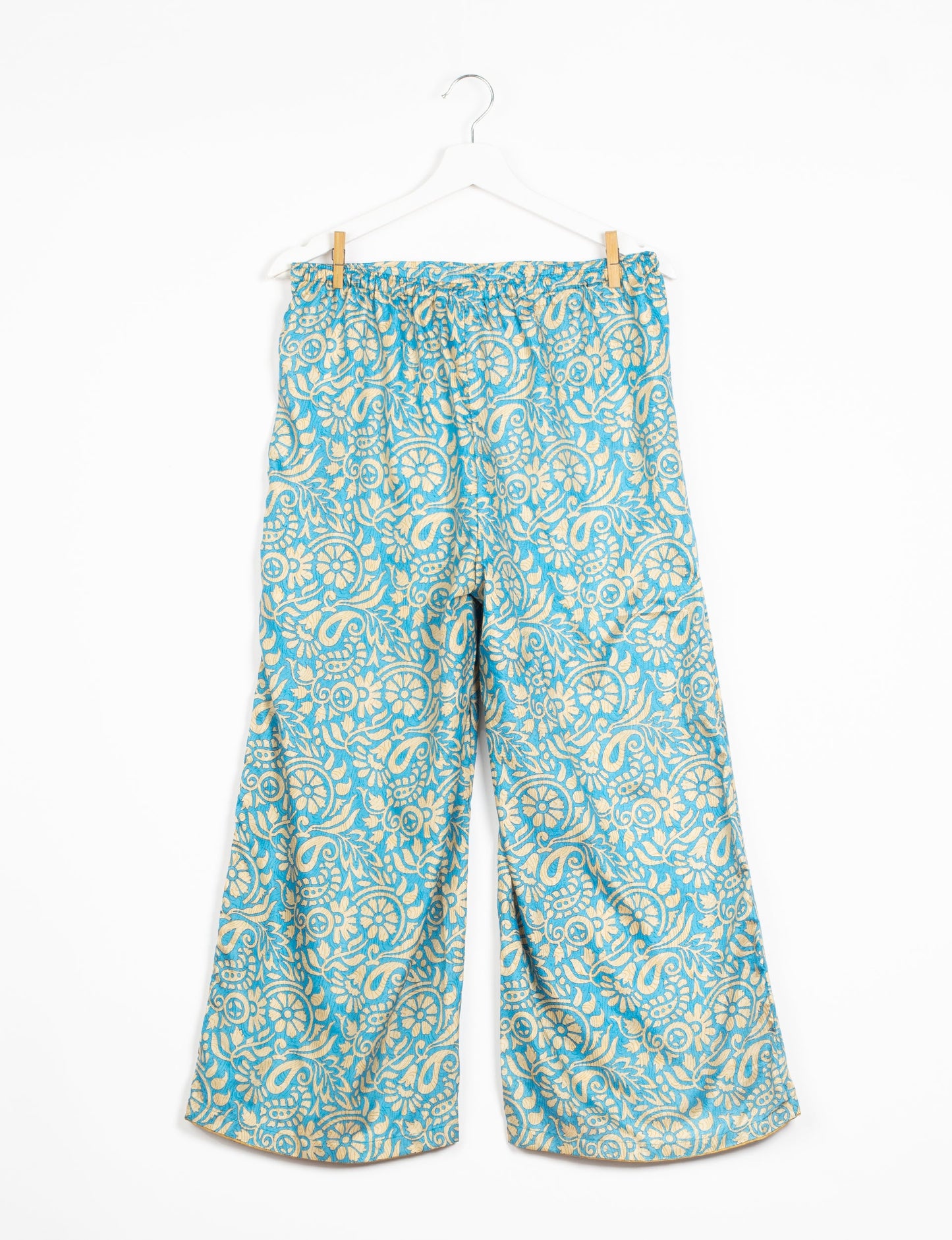 Step into sustainable fashion with our Palazzo Pants – a harmonious blend of Indian and Italian influences. These wide-legged pants, made from upcycled saris, offer comfort with an all-around elastic waist and a stylish flared leg. Make a statement with eco-friendly, chic palazzo pants that redefine ethical clothing.