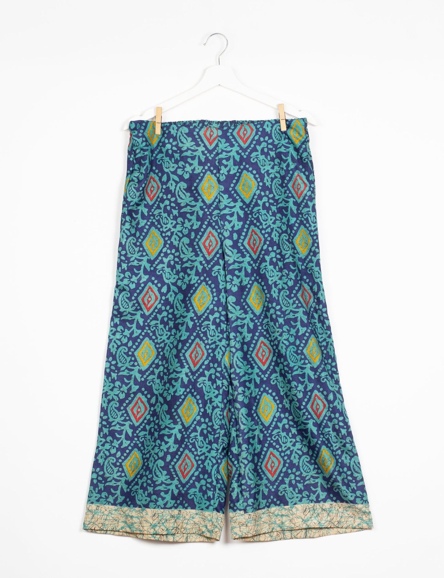 Step into sustainable fashion with our Palazzo Pants – a harmonious blend of Indian and Italian influences. These wide-legged pants, made from upcycled saris, offer comfort with an all-around elastic waist and a stylish flared leg. Make a statement with eco-friendly, chic palazzo pants that redefine ethical clothing.