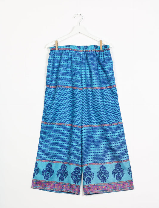 Step into sustainable fashion with our Palazzo Pants – a harmonious blend of Indian and Italian influences. These wide-legged pants, made from upcycled saris, offer comfort with an all-around elastic waist and a stylish flared leg. Make a statement with eco-friendly, chic palazzo pants that redefine ethical clothing.