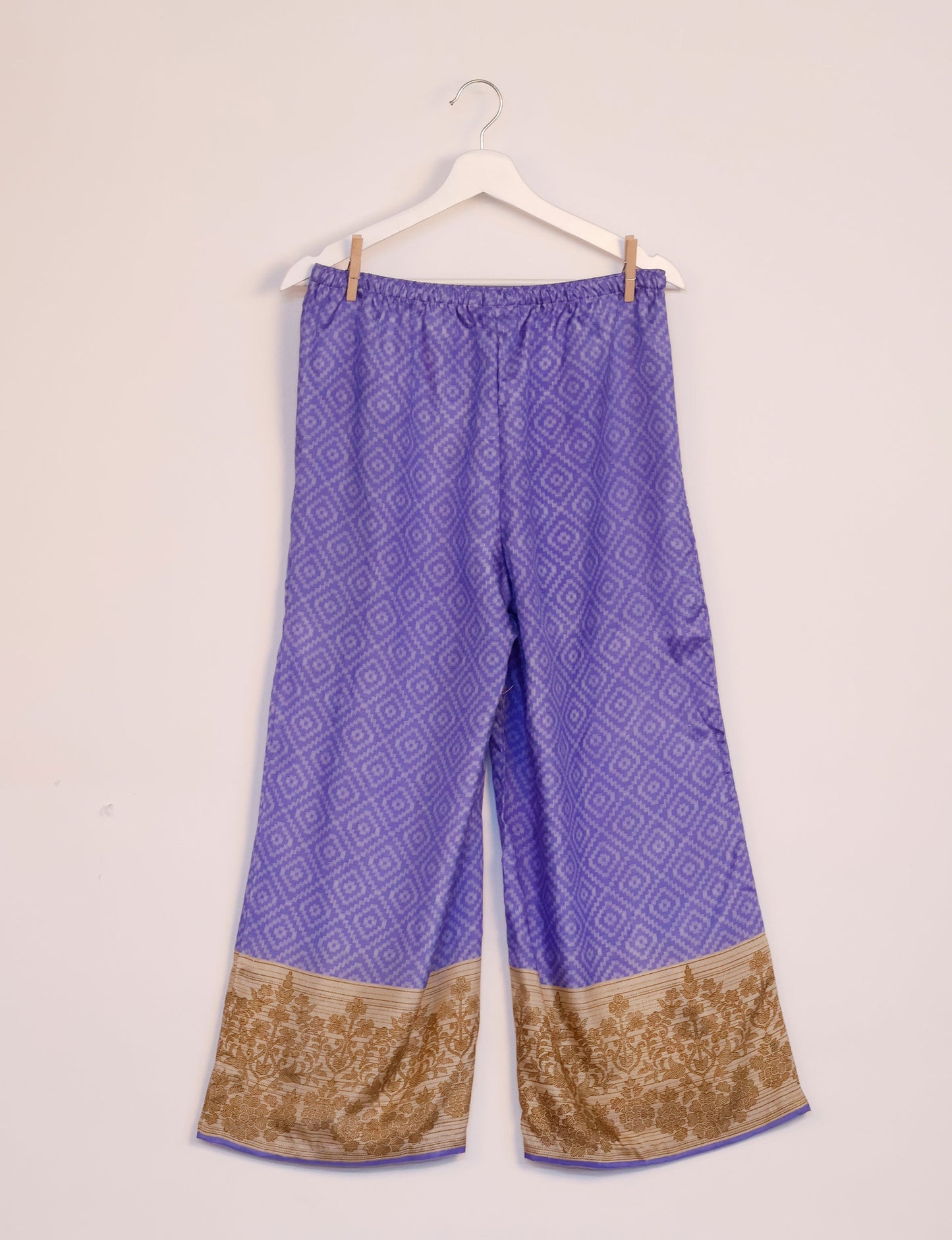 Step into sustainable fashion with our Palazzo Pants – a harmonious blend of Indian and Italian influences. These wide-legged pants, made from upcycled saris, offer comfort with an all-around elastic waist and a stylish flared leg. Make a statement with eco-friendly, chic palazzo pants that redefine ethical clothing.