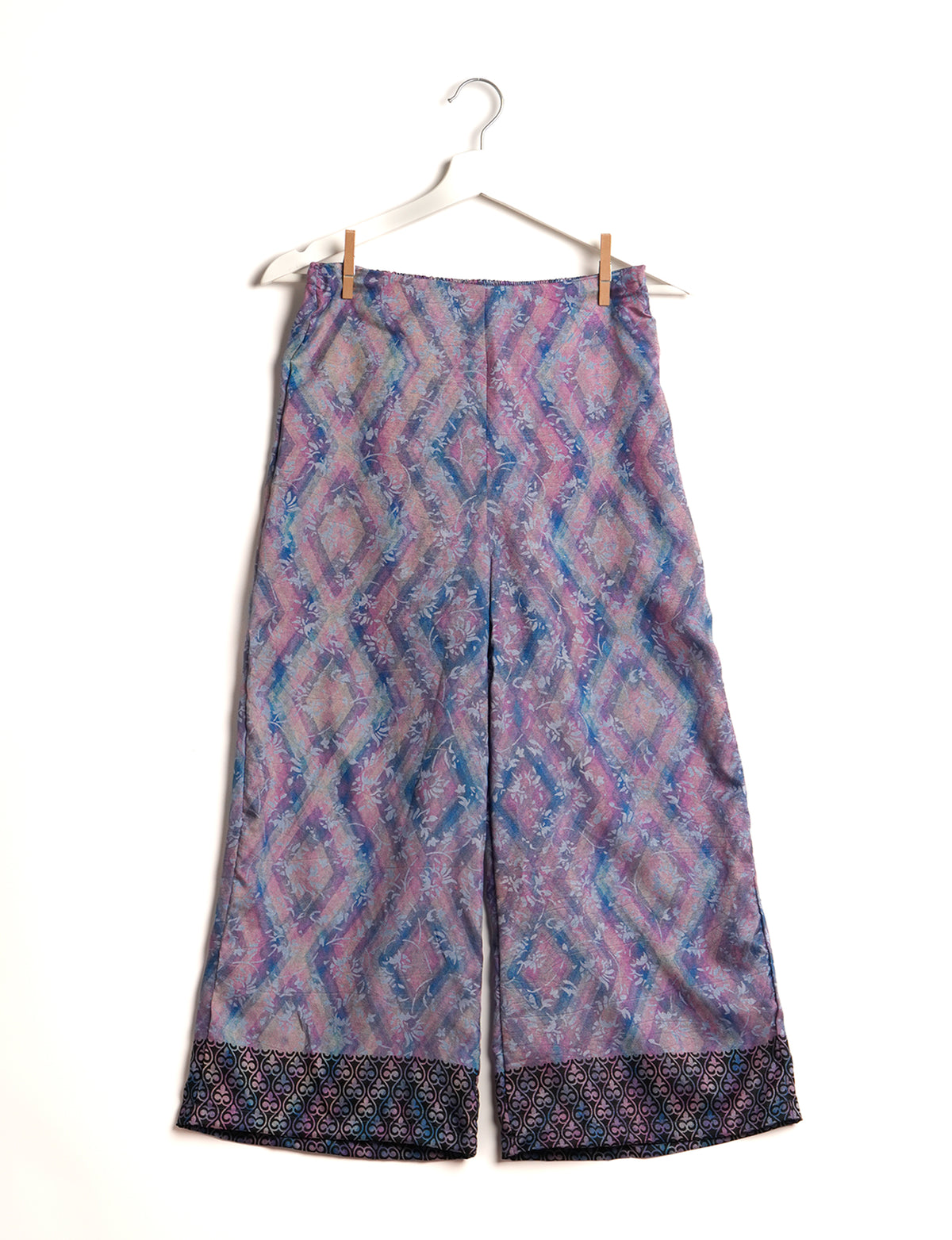 Step into sustainable fashion with our Palazzo Pants – a harmonious blend of Indian and Italian influences. These wide-legged pants, made from upcycled saris, offer comfort with an all-around elastic waist and a stylish flared leg. Make a statement with eco-friendly, chic palazzo pants that redefine ethical clothing.