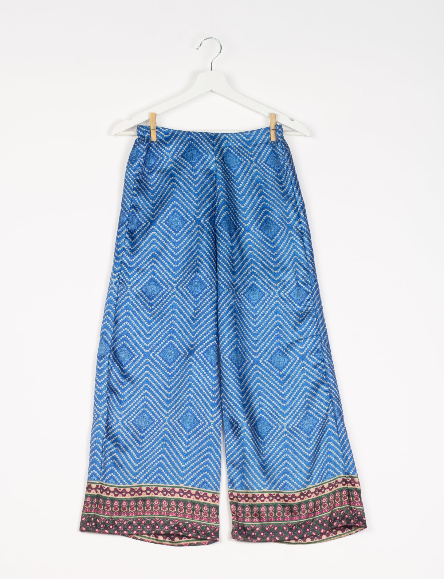 Step into sustainable fashion with our Palazzo Pants – a harmonious blend of Indian and Italian influences. These wide-legged pants, made from upcycled saris, offer comfort with an all-around elastic waist and a stylish flared leg. Make a statement with eco-friendly, chic palazzo pants that redefine ethical clothing.