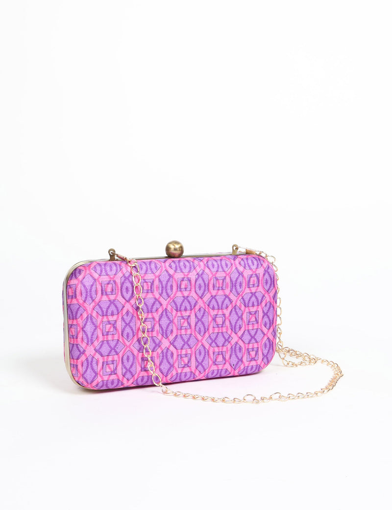 Rectangular pink and purple geometric patterned clutch handbag with gold-tone frame, clasp, and chain strap, front view