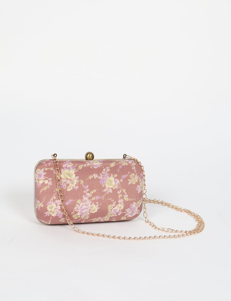 Pink floral clutch handbag with gold-tone frame and chain strap, front view on white background