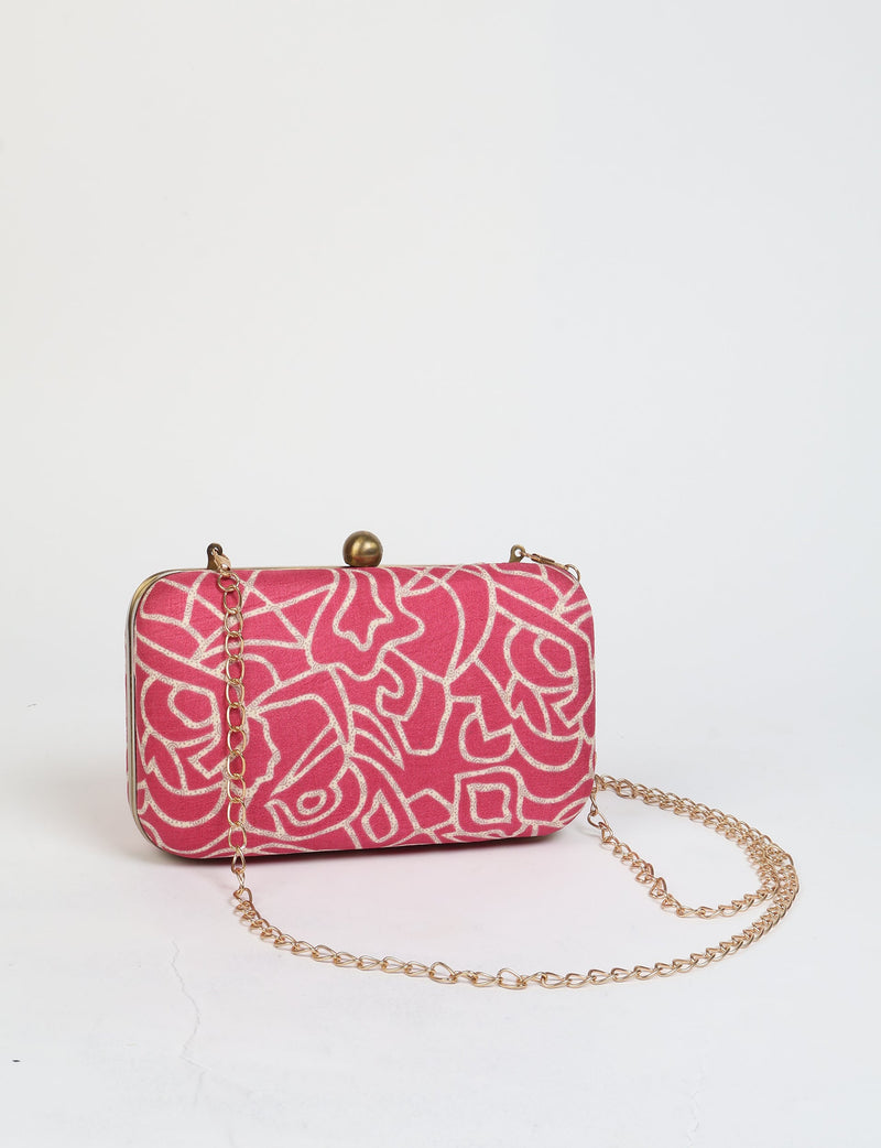 Pink clutch handbag with abstract white pattern and gold chain strap, front view on white background