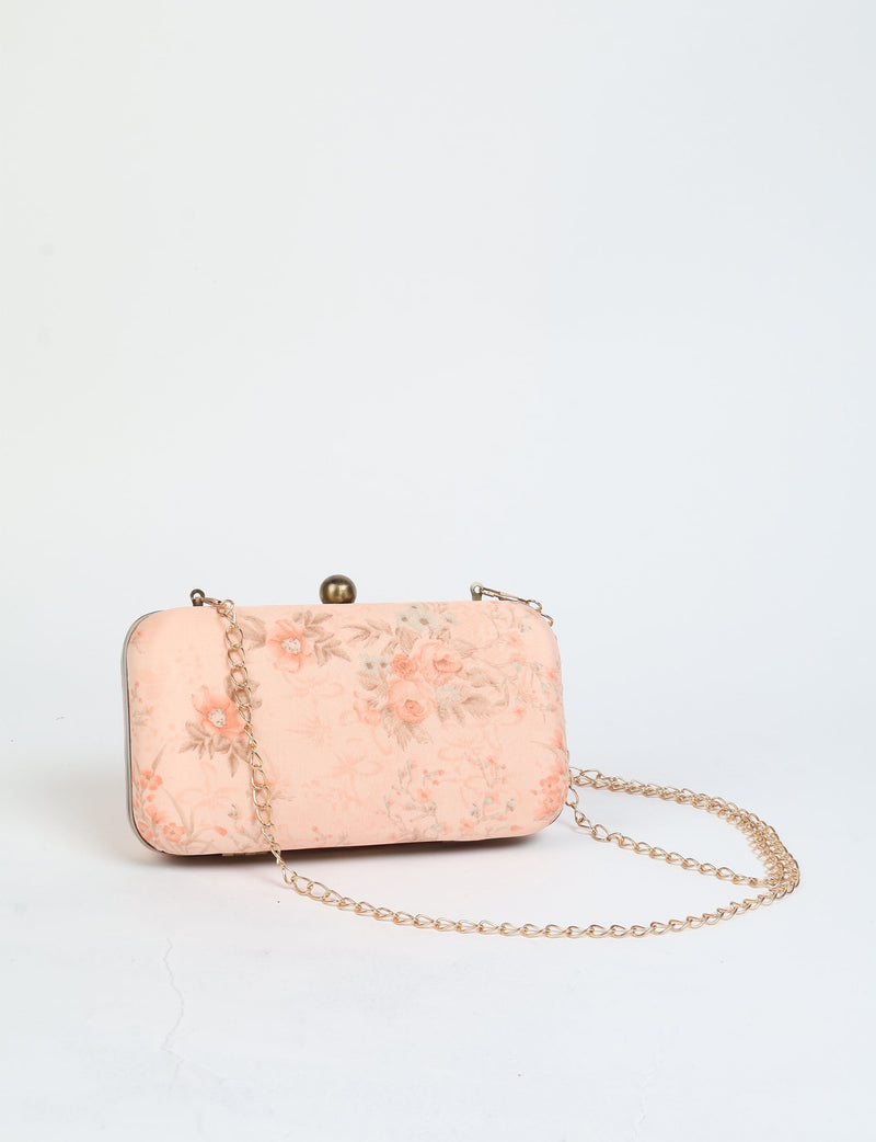 Pink tropical floral clutch handbag with gold chain strap and round clasp, front view on white background