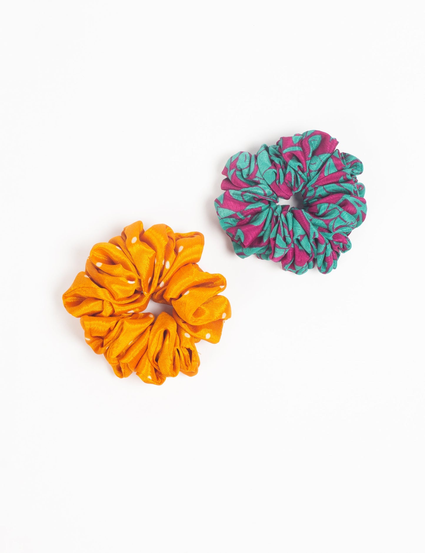 Upgrade your hairstyle with our Scrunchy Set of 2 – elastic hair ties wrapped in colorful Indian sari fabric. A top pick in ethical and green fashion, these eco-friendly prints add flair to your wrist and hair, making a sustainable style statement that catches attention and sparks change.