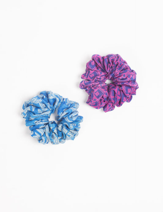 Upgrade your hairstyle with our Scrunchy Set of 2 – elastic hair ties wrapped in colorful Indian sari fabric. A top pick in ethical and green fashion, these eco-friendly prints add flair to your wrist and hair, making a sustainable style statement that catches attention and sparks change.