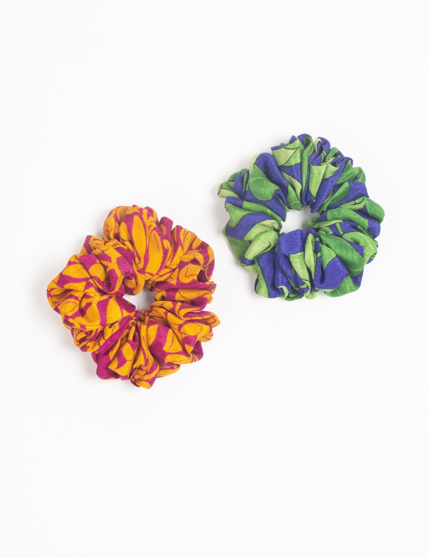 Upgrade your hairstyle with our Scrunchy Set of 2 – elastic hair ties wrapped in colorful Indian sari fabric. A top pick in ethical and green fashion, these eco-friendly prints add flair to your wrist and hair, making a sustainable style statement that catches attention and sparks change.