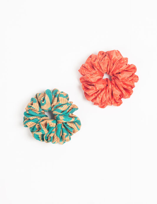 Upgrade your hairstyle with our Scrunchy Set of 2 – elastic hair ties wrapped in colorful Indian sari fabric. A top pick in ethical and green fashion, these eco-friendly prints add flair to your wrist and hair, making a sustainable style statement that catches attention and sparks change.