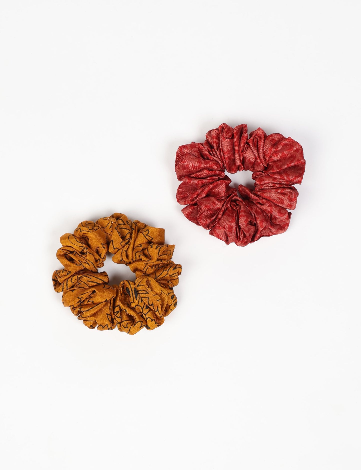 Upgrade your hairstyle with our Scrunchy Set of 2 – elastic hair ties wrapped in colorful Indian sari fabric. A top pick in ethical and green fashion, these eco-friendly prints add flair to your wrist and hair, making a sustainable style statement that catches attention and sparks change.