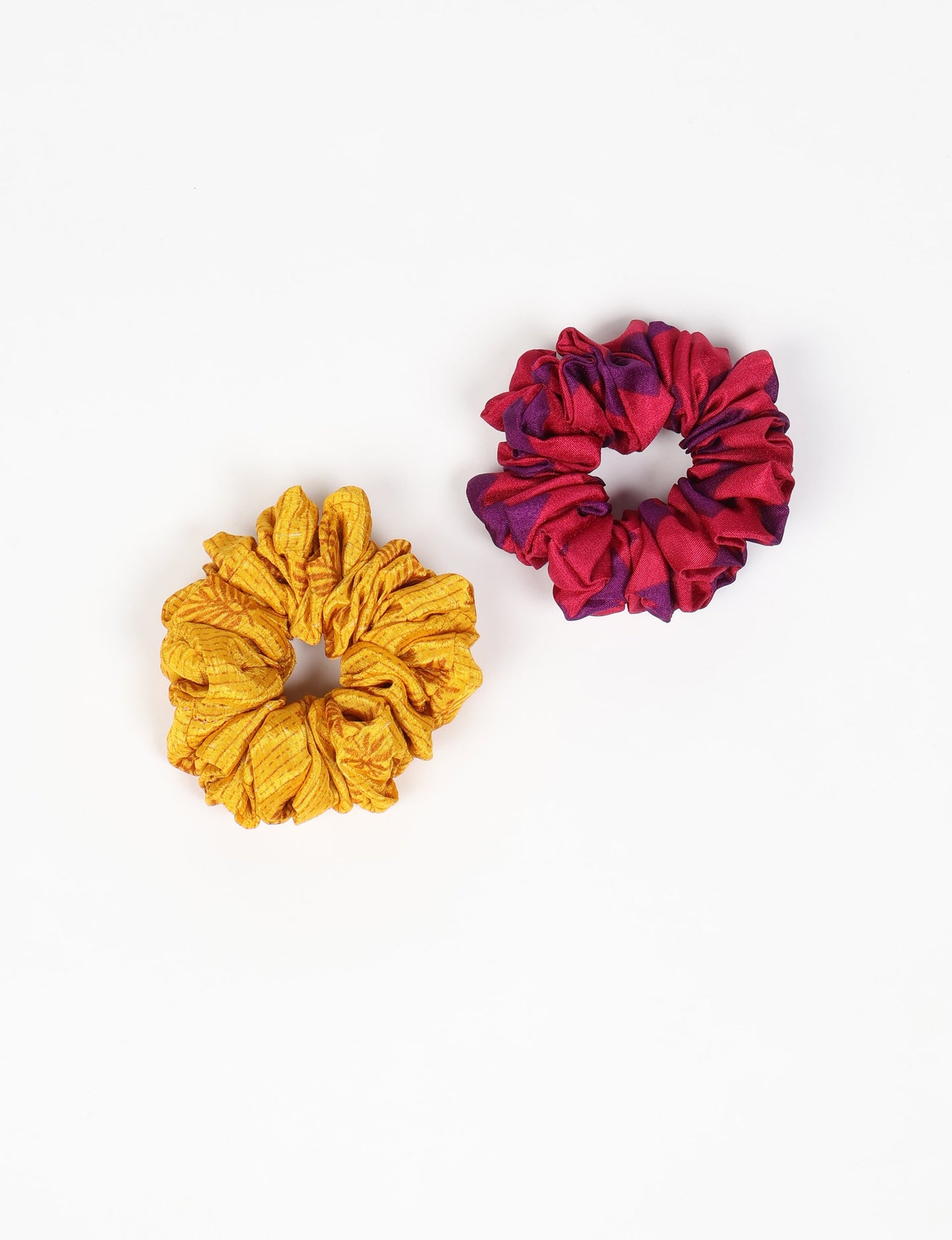 Upgrade your hairstyle with our Scrunchy Set of 2 – elastic hair ties wrapped in colorful Indian sari fabric. A top pick in ethical and green fashion, these eco-friendly prints add flair to your wrist and hair, making a sustainable style statement that catches attention and sparks change.