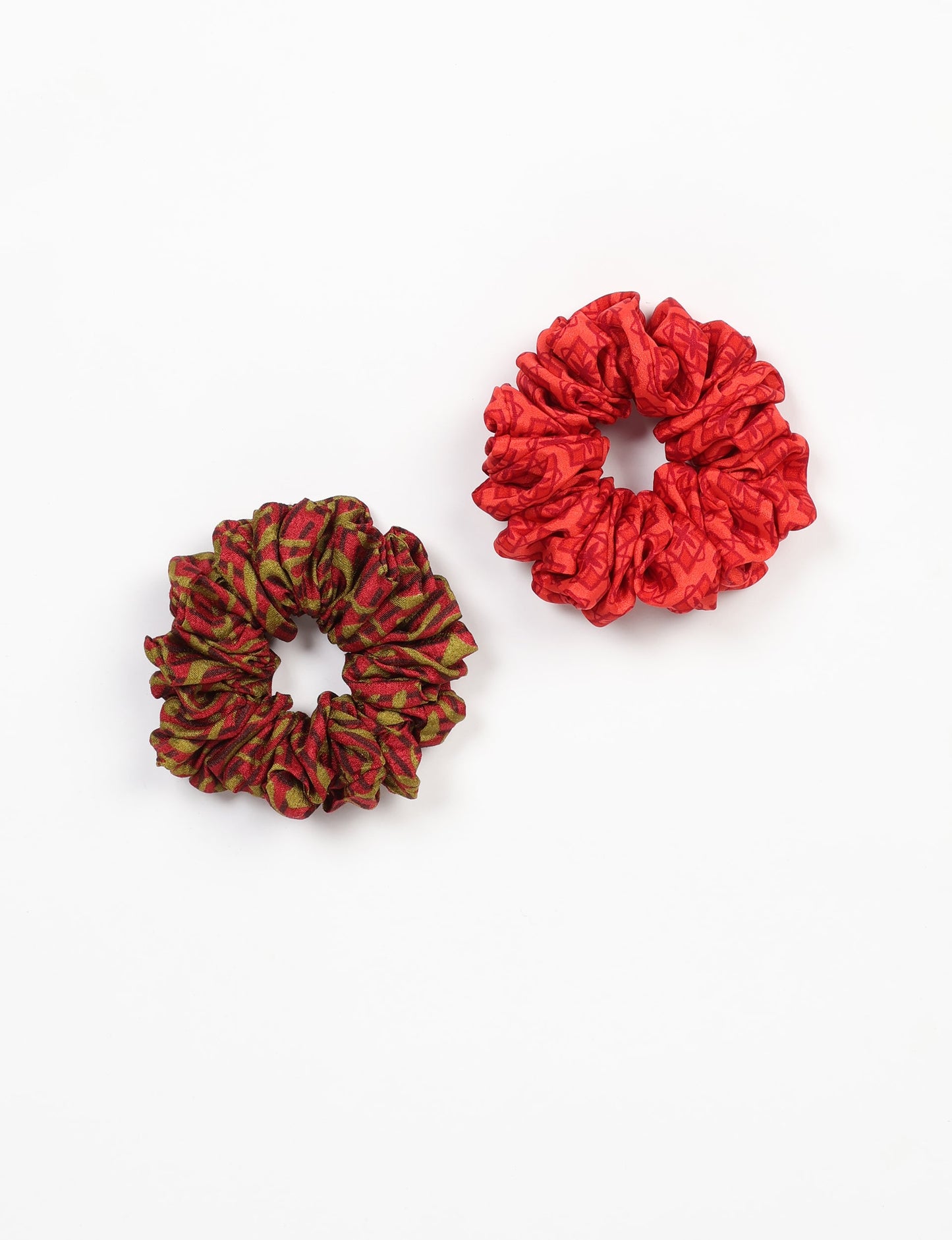 Upgrade your hairstyle with our Scrunchy Set of 2 – elastic hair ties wrapped in colorful Indian sari fabric. A top pick in ethical and green fashion, these eco-friendly prints add flair to your wrist and hair, making a sustainable style statement that catches attention and sparks change.