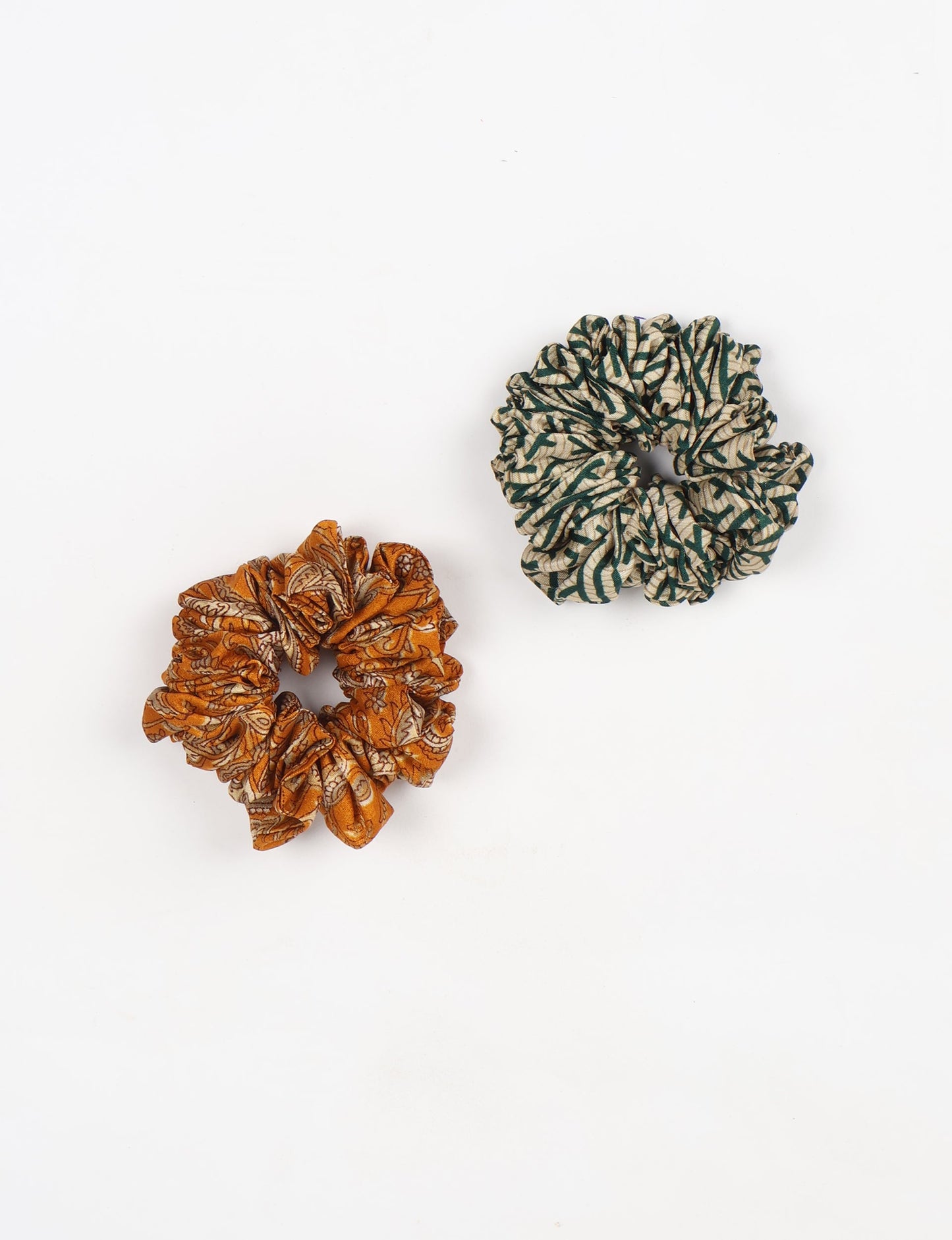 Upgrade your hairstyle with our Scrunchy Set of 2 – elastic hair ties wrapped in colorful Indian sari fabric. A top pick in ethical and green fashion, these eco-friendly prints add flair to your wrist and hair, making a sustainable style statement that catches attention and sparks change.