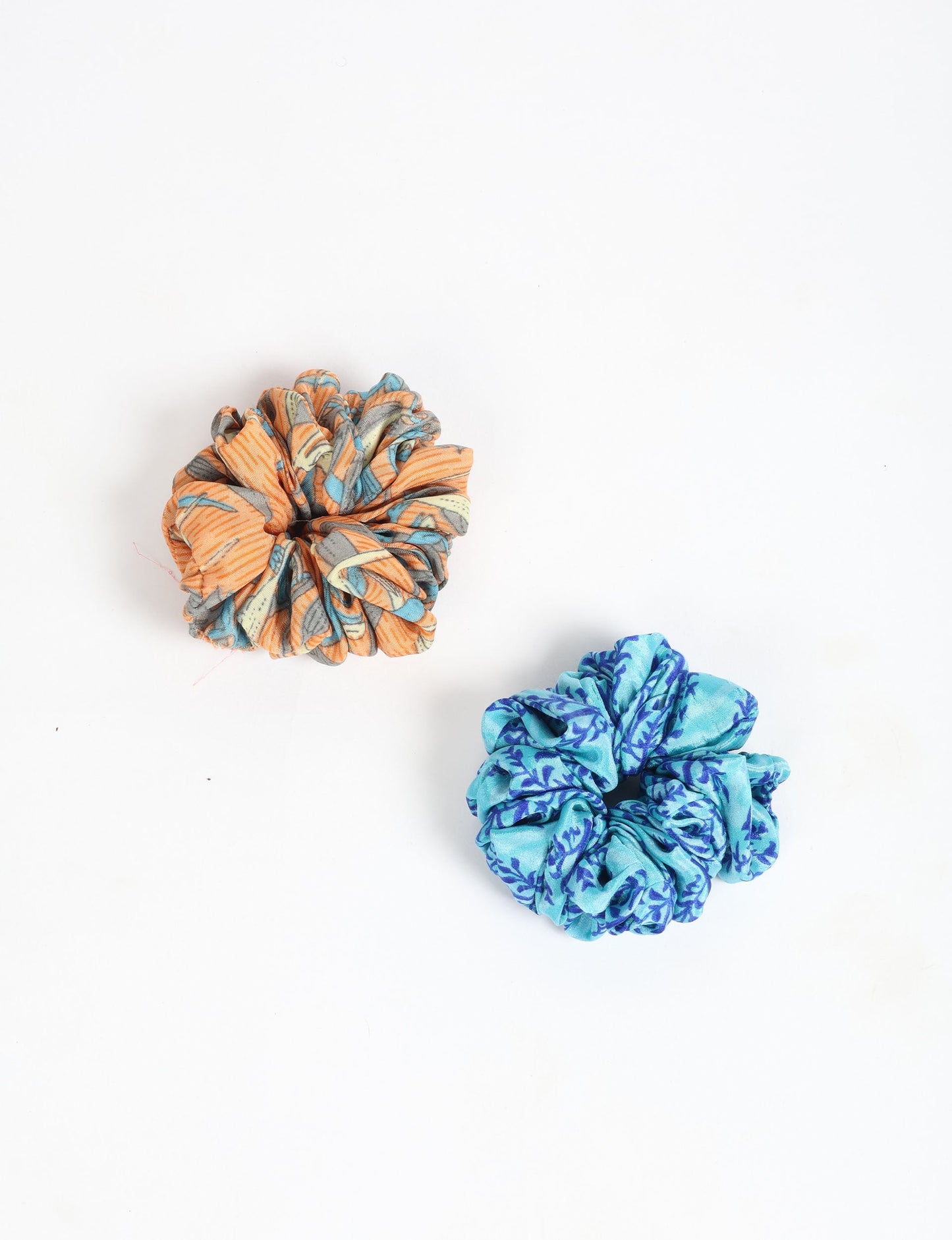 Upgrade your hairstyle with our Scrunchy Set of 2 – elastic hair ties wrapped in colorful Indian sari fabric. A top pick in ethical and green fashion, these eco-friendly prints add flair to your wrist and hair, making a sustainable style statement that catches attention and sparks change.