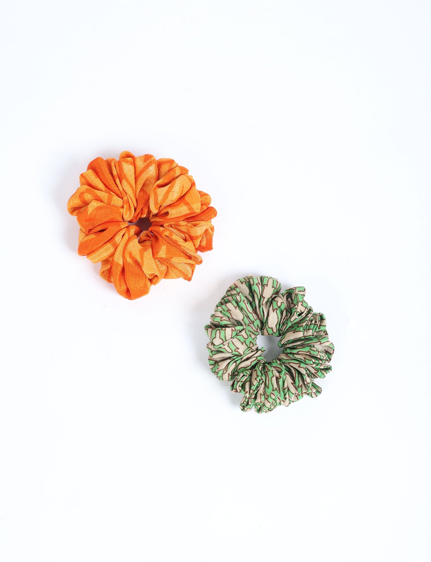 Upgrade your hairstyle with our Scrunchy Set of 2 – elastic hair ties wrapped in colorful Indian sari fabric. A top pick in ethical and green fashion, these eco-friendly prints add flair to your wrist and hair, making a sustainable style statement that catches attention and sparks change.