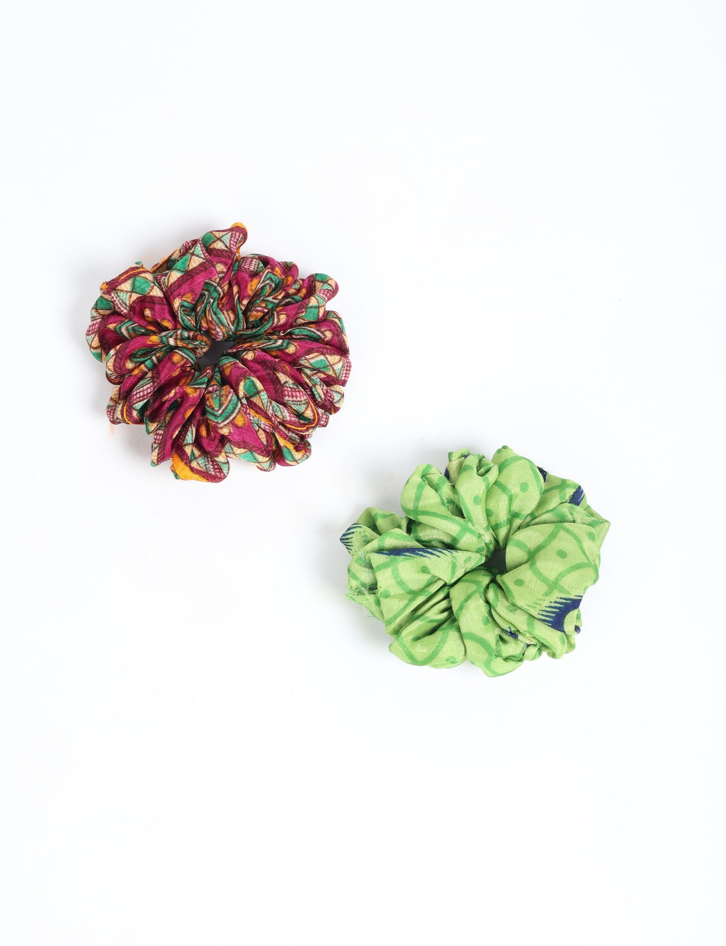 Upgrade your hairstyle with our Scrunchy Set of 2 – elastic hair ties wrapped in colorful Indian sari fabric. A top pick in ethical and green fashion, these eco-friendly prints add flair to your wrist and hair, making a sustainable style statement that catches attention and sparks change.