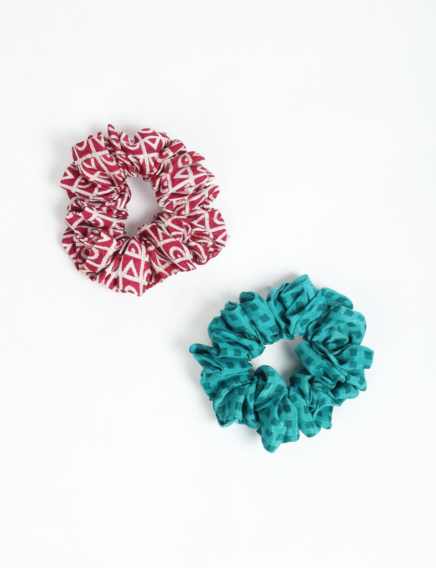 Upgrade your hairstyle with our Scrunchy Set of 2 – elastic hair ties wrapped in colorful Indian sari fabric. A top pick in ethical and green fashion, these eco-friendly prints add flair to your wrist and hair, making a sustainable style statement that catches attention and sparks change.