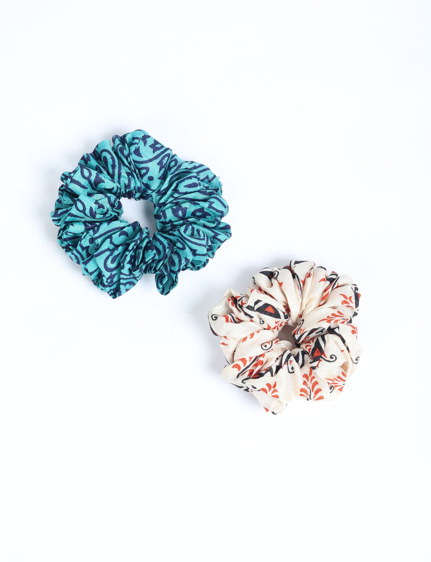 Upgrade your hairstyle with our Scrunchy Set of 2 – elastic hair ties wrapped in colorful Indian sari fabric. A top pick in ethical and green fashion, these eco-friendly prints add flair to your wrist and hair, making a sustainable style statement that catches attention and sparks change.
