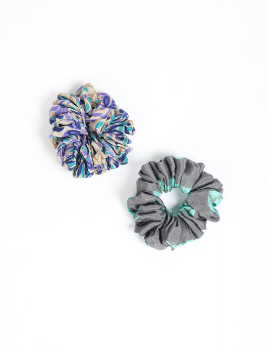 Upgrade your hairstyle with our Scrunchy Set of 2 – elastic hair ties wrapped in colorful Indian sari fabric. A top pick in ethical and green fashion, these eco-friendly prints add flair to your wrist and hair, making a sustainable style statement that catches attention and sparks change.