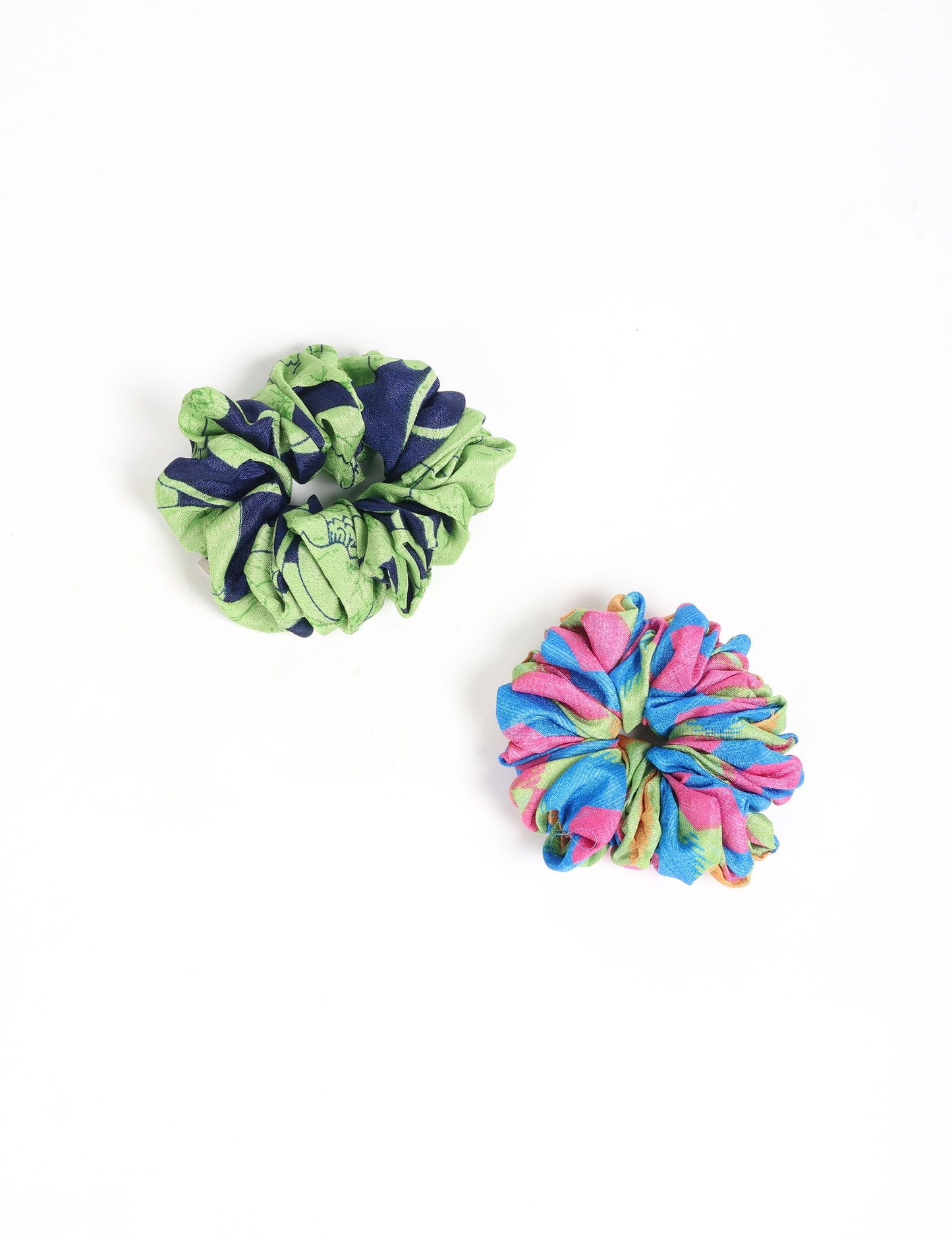 Upgrade your hairstyle with our Scrunchy Set of 2 – elastic hair ties wrapped in colorful Indian sari fabric. A top pick in ethical and green fashion, these eco-friendly prints add flair to your wrist and hair, making a sustainable style statement that catches attention and sparks change.