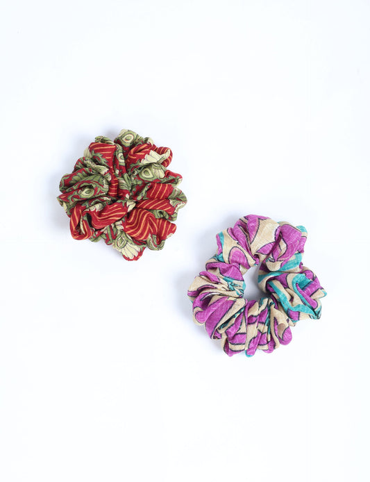 Upgrade your hairstyle with our Scrunchy Set of 2 – elastic hair ties wrapped in colorful Indian sari fabric. A top pick in ethical and green fashion, these eco-friendly prints add flair to your wrist and hair, making a sustainable style statement that catches attention and sparks change.