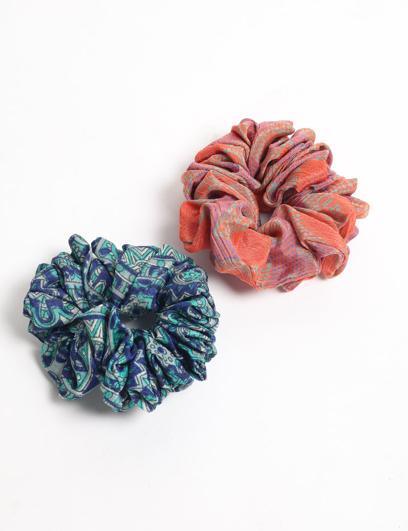 Set of two fabric scrunchies with assorted colorful geometric patterns, shown flat on a white background