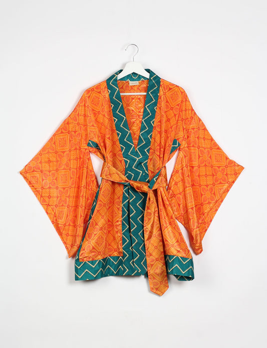 Radiant and sustainably crafted KIMONO with humble beginnings from the streets of India. Versatile and eco-friendly layering piece for casual trousers, swimwear, or our spaghetti strap dress. Embrace conscious fashion and sustainable style with this unique and culturally inspired kimono, sure to invite compliments.