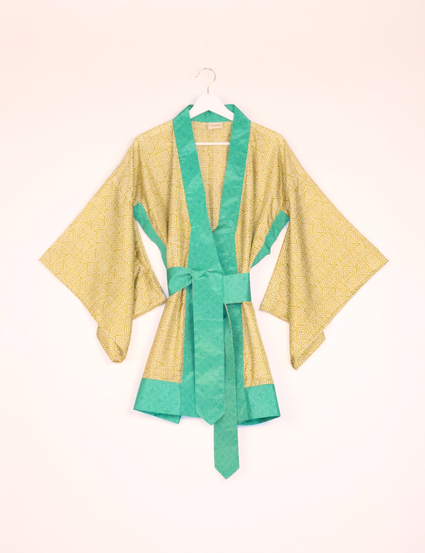 Radiant and sustainably crafted KIMONO with humble beginnings from the streets of India. Versatile and eco-friendly layering piece for casual trousers, swimwear, or our spaghetti strap dress. Embrace conscious fashion and sustainable style with this unique and culturally inspired kimono, sure to invite compliments.