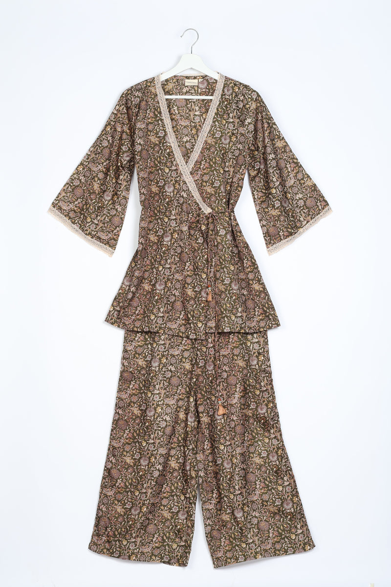 Brown tropical floral print tunic set with lace trim, wrap front, tie waist, and wide-leg pants, flat lay on white background
