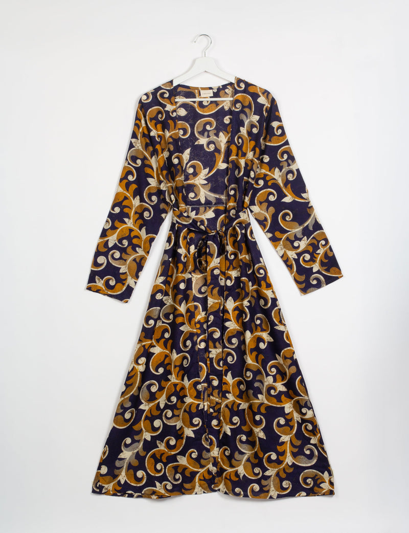 Blue beach robe with Indian ethnic pattern in mustard and cream, long sleeves, belt, front view on hanger