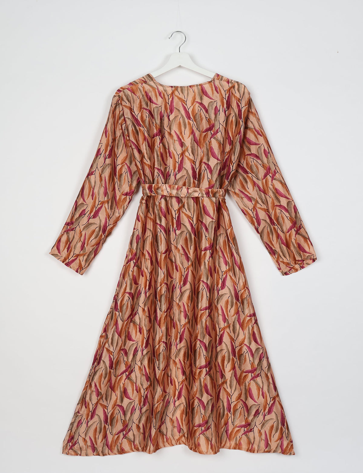 Beige beach robe with long sleeves and belt, featuring a multicolor leaf pattern in orange, pink, and brown, shown flat on