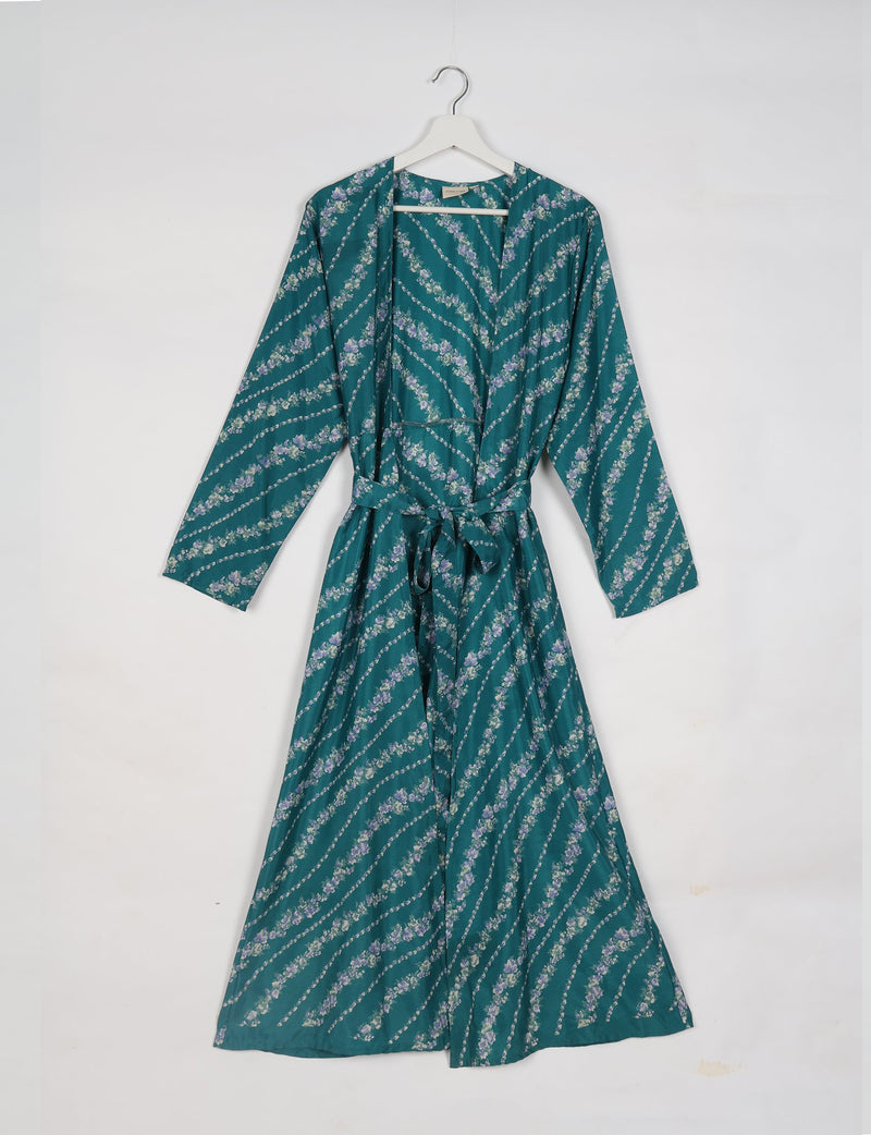 Blue-green beach robe with diagonal floral stripes, long sleeves, and a waist tie, hanging on a white hanger