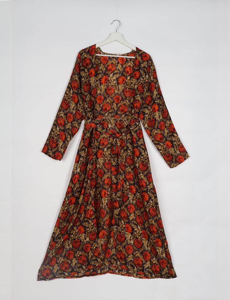 Brown floral beach robe with long sleeves and waist tie, hanging on white hanger against white background