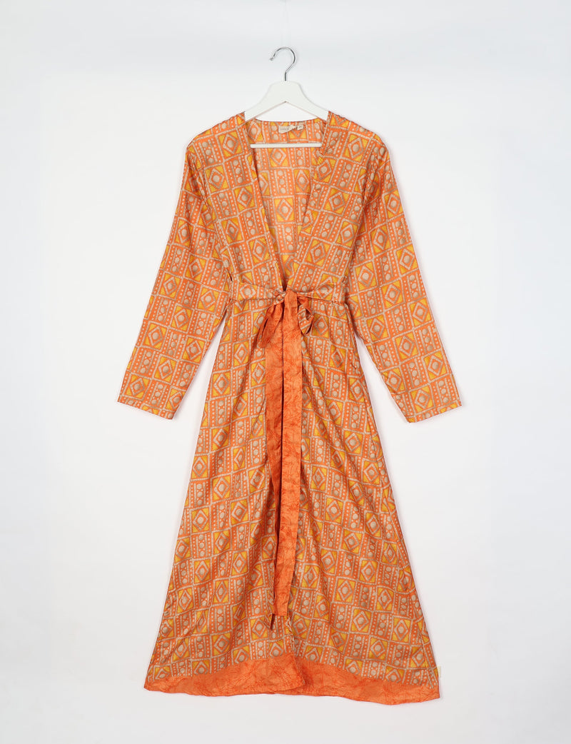 Long-sleeve beach robe with yellow and orange geometric pattern, front tie belt, and solid orange trim, hanging on white hanger