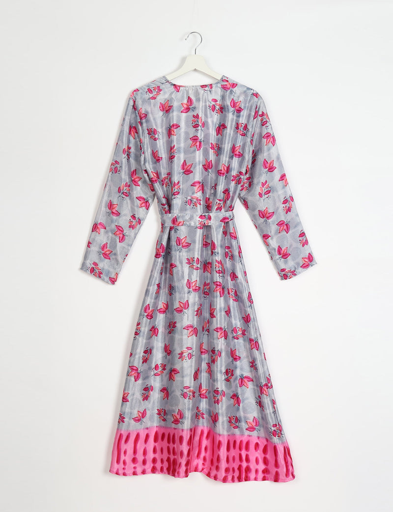 Long-sleeve beach robe with pink leaf print on gray background and bright pink patterned hem, hanging on white hanger