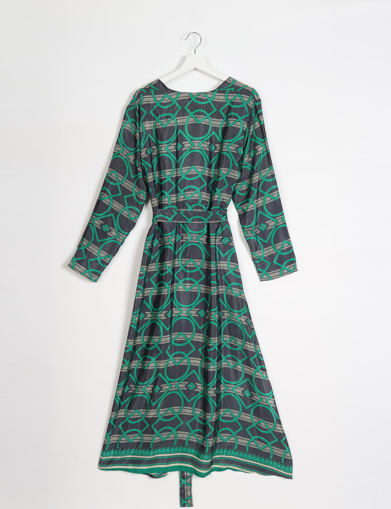 Green and black geometric patterned long-sleeve beach robe with belt, shown hanging on white hanger, back view