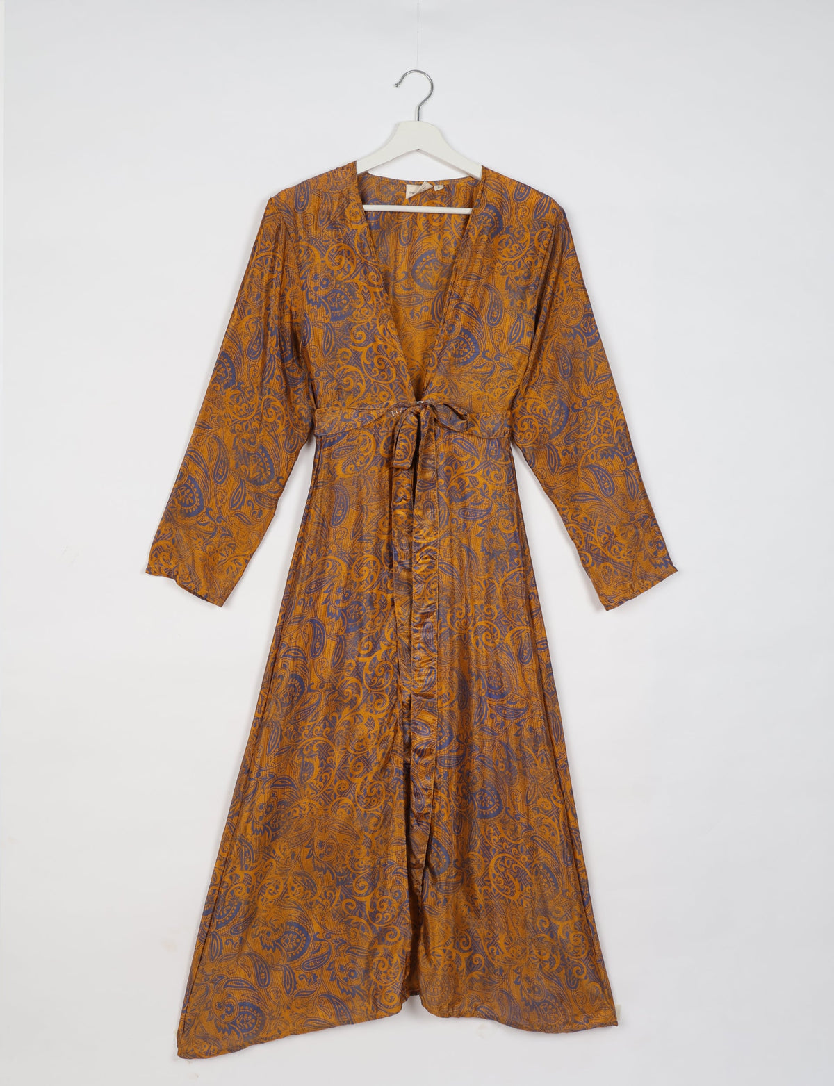 Yellow and purple paisley patterned long-sleeve beach robe with V-neck and waist tie, hanging on white hanger