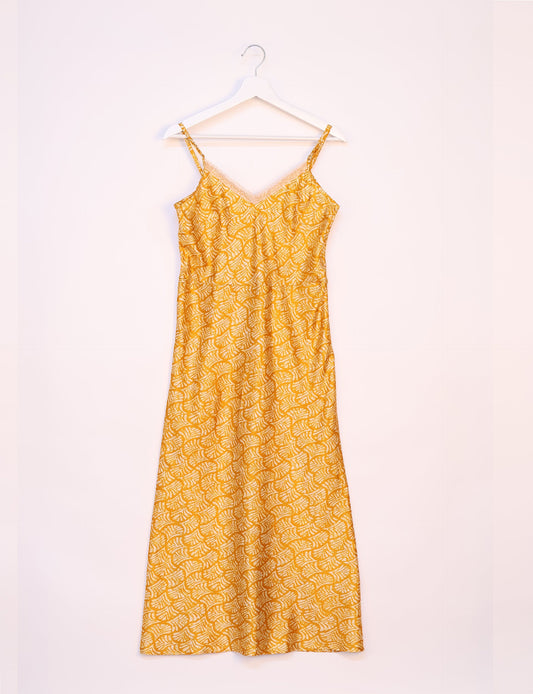 Spaghetti strap dress made from sustainable materials, embodying ethical fashion principles. Ideal for eco-friendly travelers seeking laid-back style.